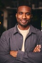 Smiling Young Black Male Standing In Office Looking At Camera With Arms Crossed Royalty Free Stock Photo