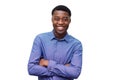 Smiling young black man in blue shirt posing with arms crossed against isolated white background Royalty Free Stock Photo