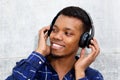 Smiling young black man with headphones listening to music Royalty Free Stock Photo