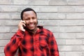 Smiling young black man talking on mobile phone Royalty Free Stock Photo