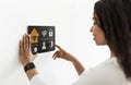 Smiling black woman using smart home system Royalty Free Stock Photo