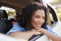 Smiling young black woman looks out of a car window Royalty Free Stock Photo