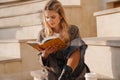 Smiling young blonde casual woman reading book Royalty Free Stock Photo