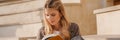 Smiling young blonde casual woman reading book Royalty Free Stock Photo