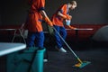 Two professional cleaners tidying up the office cafeteria Royalty Free Stock Photo