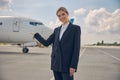 Cheerful Caucasian woman pointing at the plane Royalty Free Stock Photo