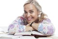 Smiling young blonde girl with a pile of books. Education and training. Isolated on white background. Close-up Royalty Free Stock Photo