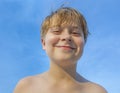 Smiling young boy with background blue sky Royalty Free Stock Photo