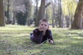 Smiling young boy lying on grass in the park Royalty Free Stock Photo