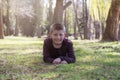 Smiling young boy lying on grass in the park Royalty Free Stock Photo