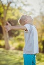 Smiling young boy standing with arms outstretched Royalty Free Stock Photo