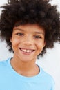 Smiling Young Boy Standing Outdoors Against White Wall Royalty Free Stock Photo