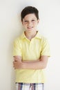 Smiling Young Boy Standing Outdoors Against White Wall Royalty Free Stock Photo