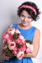 Smiling young brunette woman with flowers Royalty Free Stock Photo