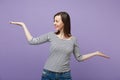 Smiling young brunette woman girl in casual striped clothes posing isolated on violet purple background studio portrait Royalty Free Stock Photo