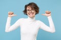 Smiling young brunette woman girl in casual white clothes eyeglasses posing isolated on pastel blue wall background in Royalty Free Stock Photo