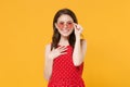 Smiling young brunette woman girl in red summer dress, eyeglasses posing isolated on yellow wall background studio Royalty Free Stock Photo