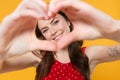 Smiling young brunette woman girl in red summer dress posing isolated on yellow background in studio. People lifestyle Royalty Free Stock Photo