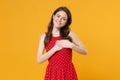 Smiling young brunette woman girl in red summer dress posing isolated on yellow background studio portrait. People Royalty Free Stock Photo