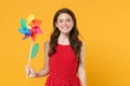 Smiling young brunette woman girl in red summer dress posing isolated on yellow wall background studio portrait. People Royalty Free Stock Photo