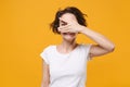 Smiling young brunette woman girl in white t-shirt posing isolated on yellow orange background studio portrait. People Royalty Free Stock Photo