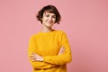 Smiling young brunette woman girl in yellow sweater posing isolated on pastel pink background studio portrait. People Royalty Free Stock Photo