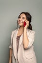Smiling young brunette woman in suit using mobile phone Royalty Free Stock Photo