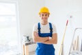 Smiling young builder in hardhat indoors