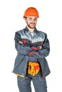 Smiling young builder, looking at camera. Repair and construction. Isolated over white background. Royalty Free Stock Photo