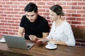 Smiling young business couple loves Asian man and caucasian woman holding credit card for online shopping and paying in social Royalty Free Stock Photo