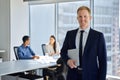 Smiling young business man corporate team leader standing in office. Portrait Royalty Free Stock Photo