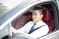 Smiling asian young business man driving a car Royalty Free Stock Photo