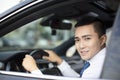 Smiling young business man driving a car Royalty Free Stock Photo