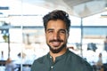 Smiling young business man looking at camera in office, headshot portrait. Royalty Free Stock Photo