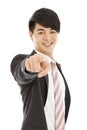 Smiling young business man point finger to camera lens