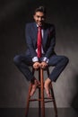 Smiling young business man sitting on a chair Royalty Free Stock Photo