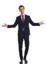 Smiling young business man in suit and tie welcoming you Royalty Free Stock Photo