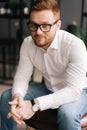 Smiling young business man wearing stylish glasses in trendy clothing looking away Royalty Free Stock Photo