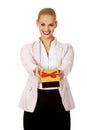 Smiling young business woman holding present box Royalty Free Stock Photo