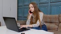 Young business woman professional consultant talking, on mobile phone, using laptop at home office Royalty Free Stock Photo