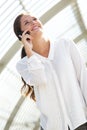 Smiling young business woman talking on cell phone Royalty Free Stock Photo