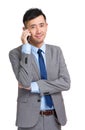 Smiling young businessman answering phone Royalty Free Stock Photo