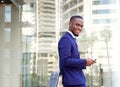 Smiling young businessman with cellphone Royalty Free Stock Photo