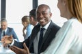 Smiling young businessman discussing with female colleague in board room Royalty Free Stock Photo