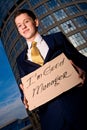 Smiling young businessman holding sign Royalty Free Stock Photo