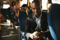 Smiling young businessman listening to music on his morning comm Royalty Free Stock Photo