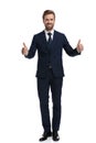 Smiling young businessman making thumbs up sign Royalty Free Stock Photo