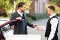 Young Businessman Giving Car Key To Valet Royalty Free Stock Photo