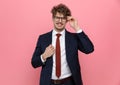 Smiling young businessman in suit fixing glasses and suit Royalty Free Stock Photo