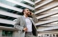 Smiling Young Businessman Talking On Cellphone While Standing Outdoors Royalty Free Stock Photo
